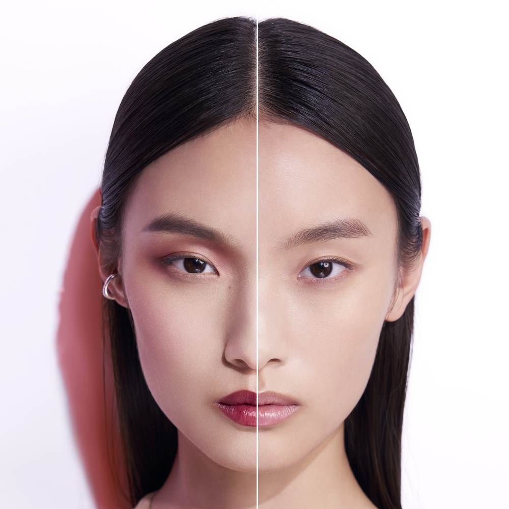 alt="Split face comparison showing the same model with bold makeup including dark red lips on the left, and a clean bare face with radiant skin after cleansing on the right, demonstrating Shu Uemura cleansing oil efficacy."