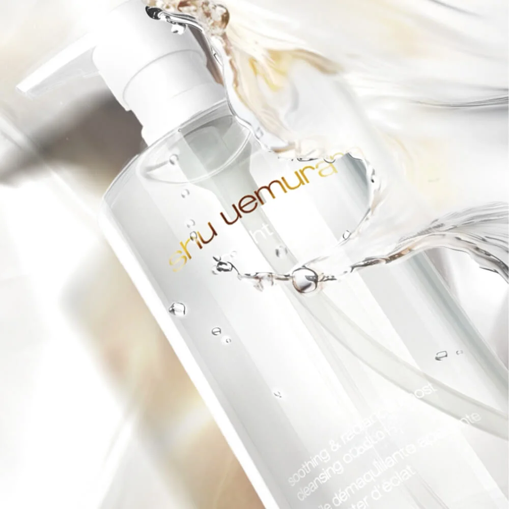 alt="Close-up of a Shu Uemura clear pump bottle of soothing and radiance-enhancing cleansing oil surrounded by water droplets and splashing liquid against a so…alt="Close-up of a Shu Uemura clear pump bottle of soothing and radiance-enhancing cleansing oil surrounded by water droplets and splashing liquid against a soft white background."