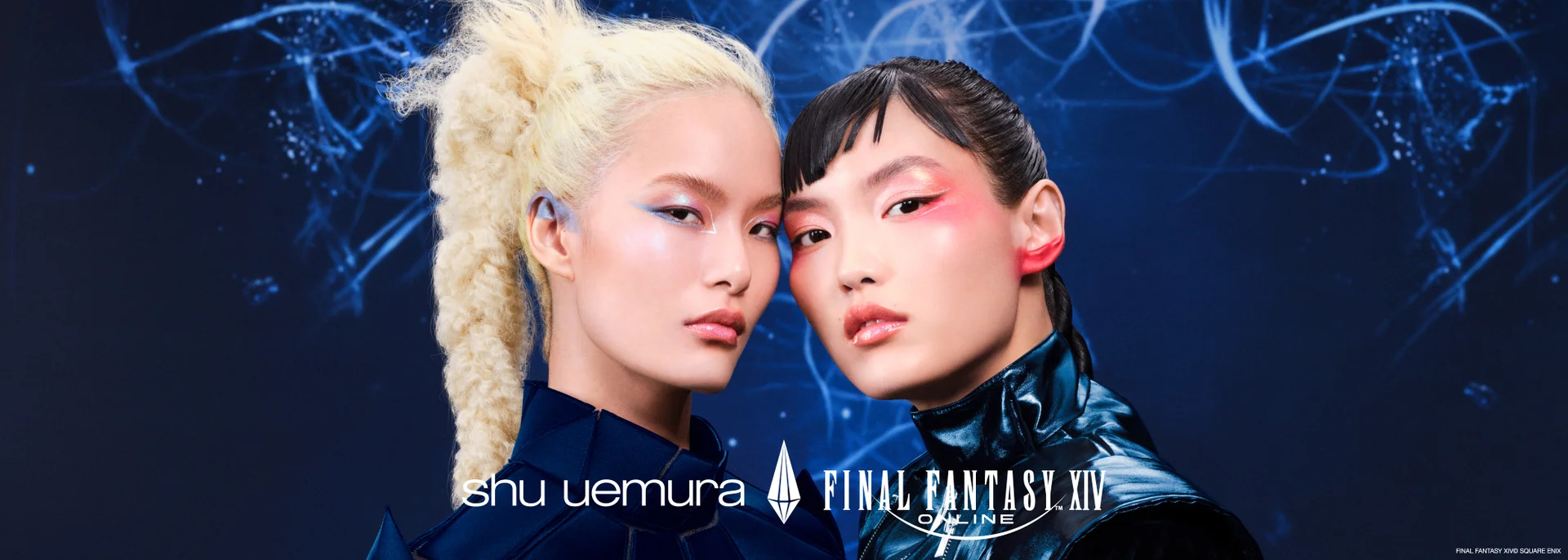 alt="Shu Uemura x Final Fantasy XIV Online square campaign image featuring two models with bold editorial makeup posed cheek to cheek against a deep blue cosmic background."